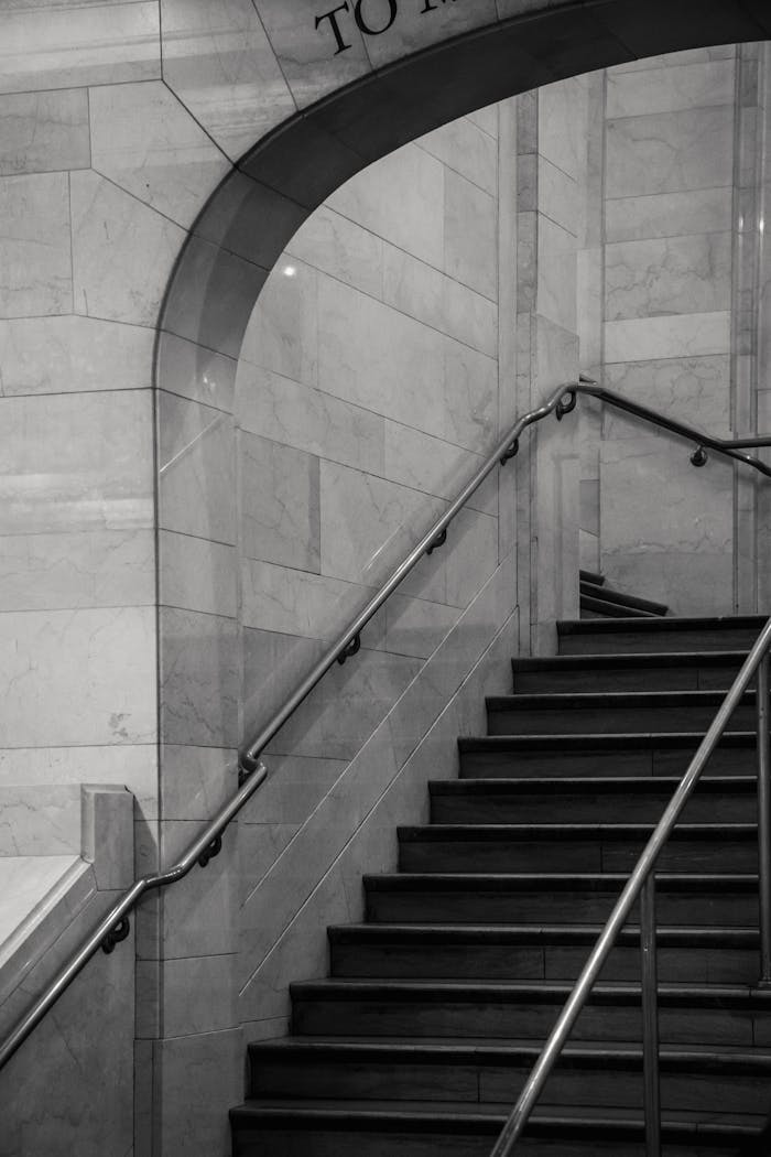 Staircase with metal railings in stone building